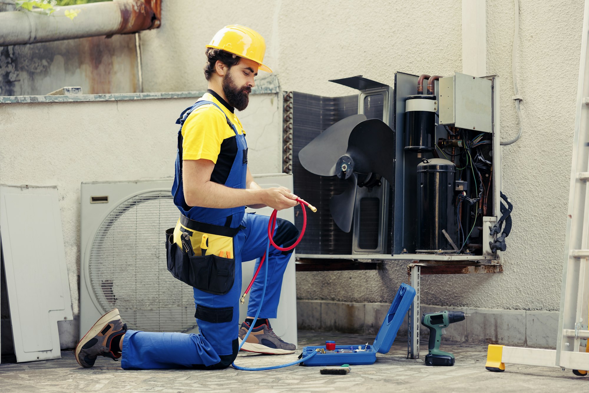 Technician maintenancing air conditioner